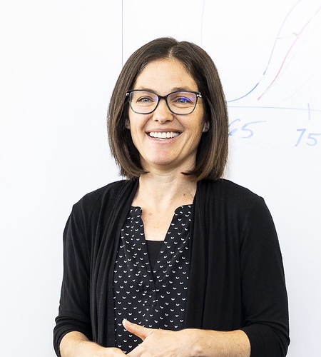 Picture of Joey Shapiro Key in front of a
                                    whiteboard with a hand-drawn plot partially visible