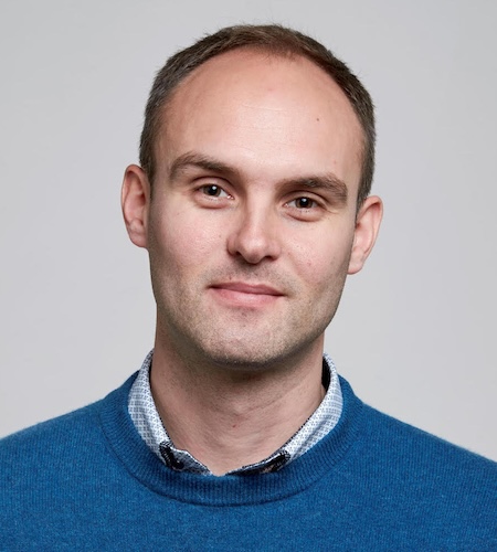 Picture of Niels Warburton in front of a white
				    background