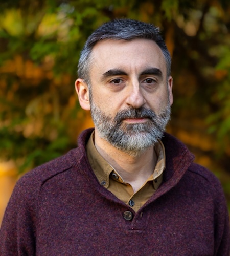 Picture of Ryan DeRosa in front of foliage